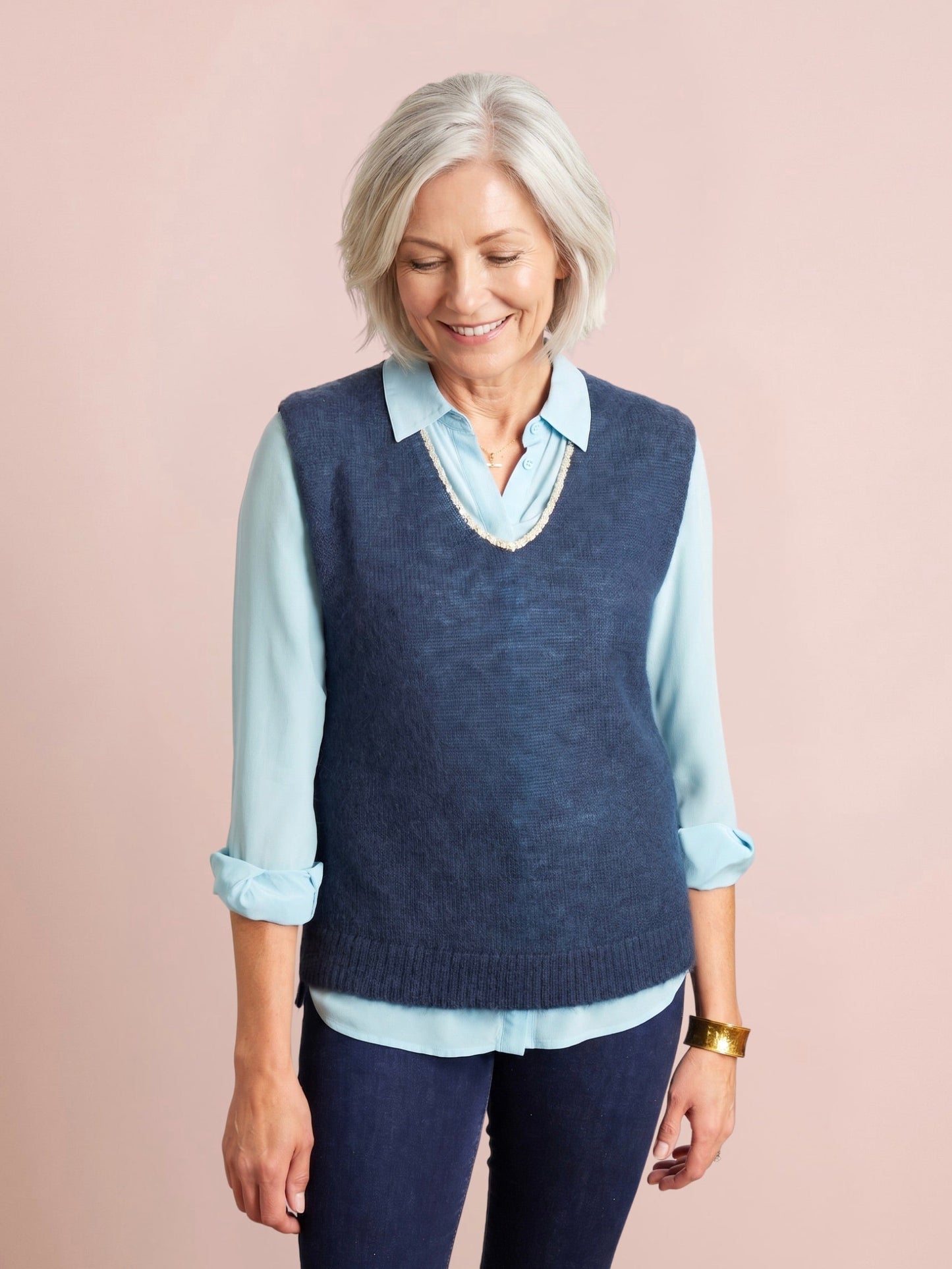 Navy blue knitted tank top with a V neck edged in subtle gold lurex trim and a wide ribbed hem in a relaxed fit