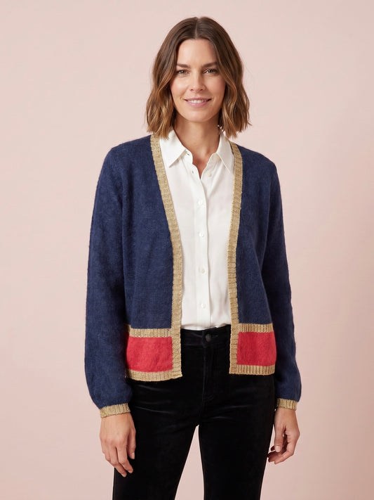 Navy blue open-front women's Sophie cardigan with gold lurex trim along the neckline hem and cuffs plus contrasting cerise pink band stripe and long sleeves
