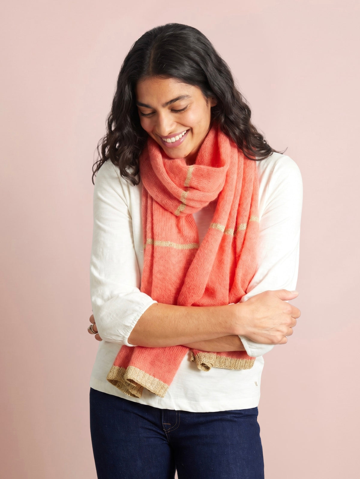 Orange scarf with subtle gold lurex stripes and detailing in a soft layered wrap